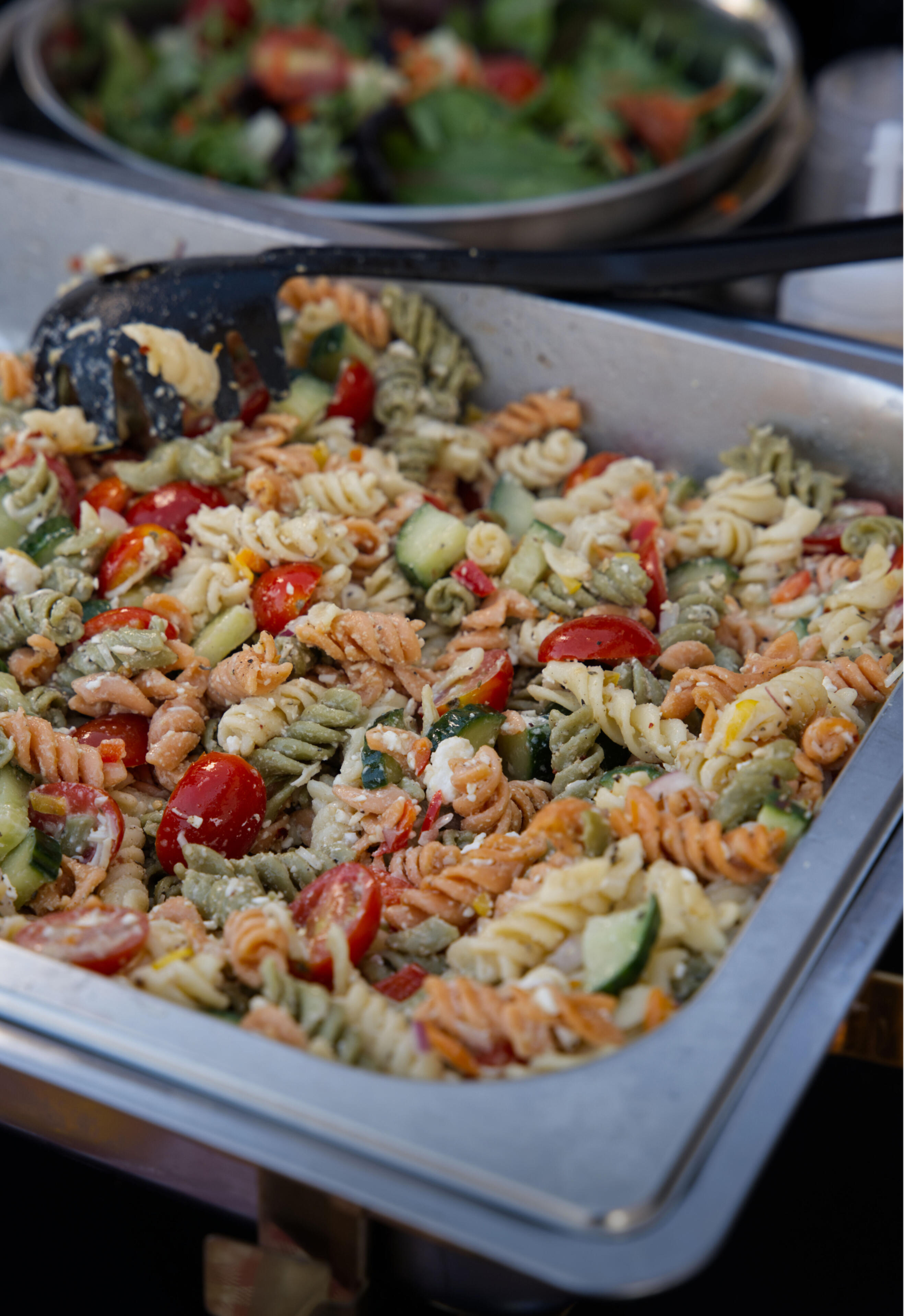 greek cold pasta with ladle on top