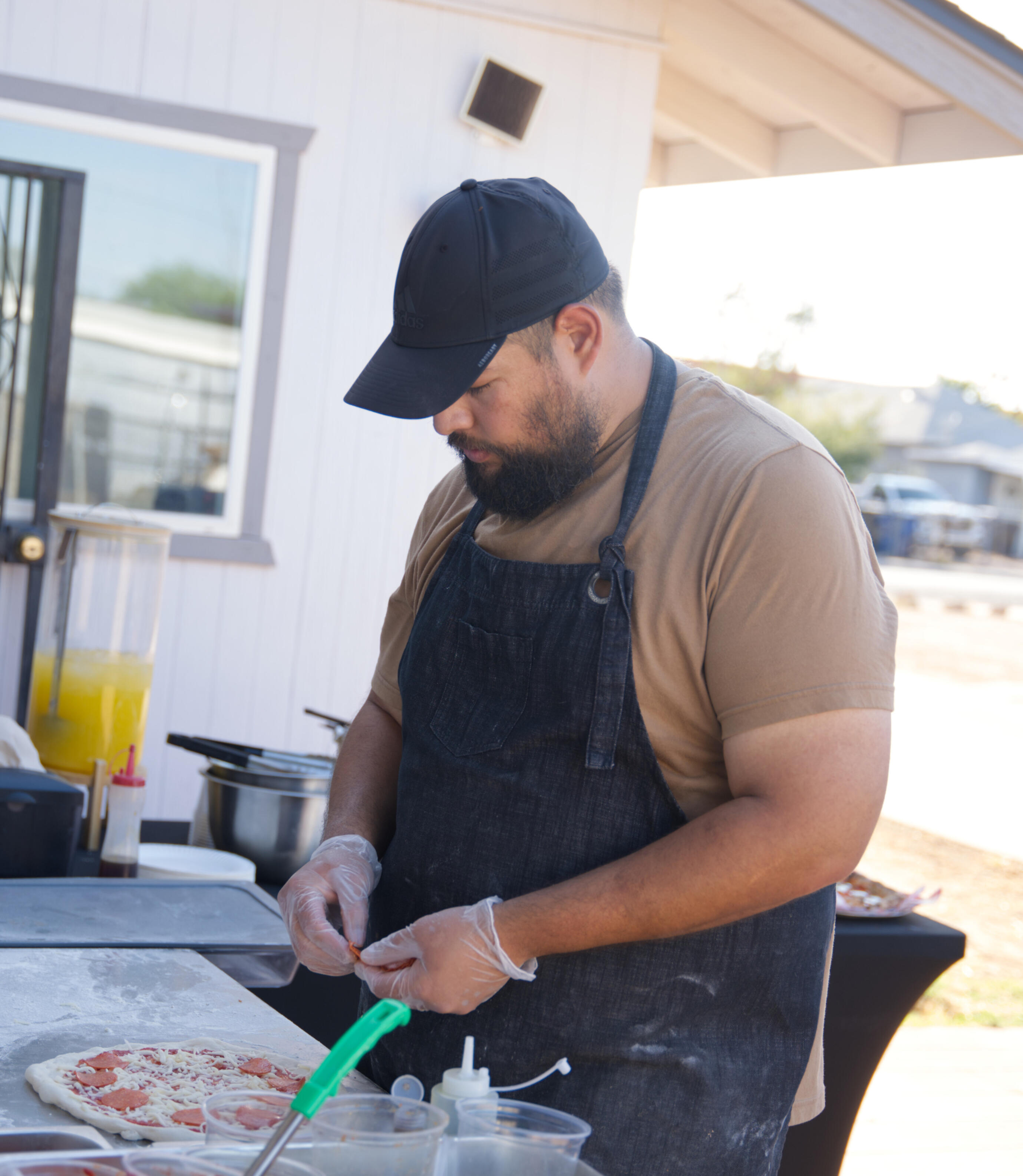 picture of a person topping a pizza