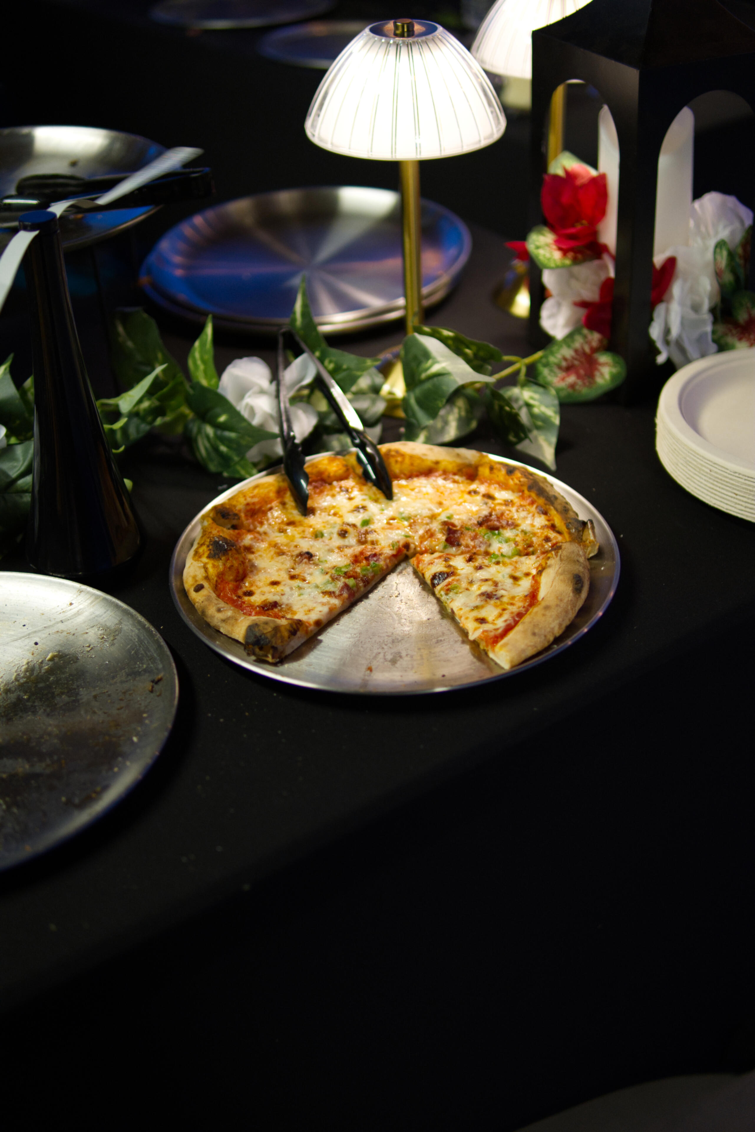 Menu picture of a person topping a pizza